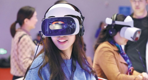 Visitors to the Light of the Internet Expo, part of the ongoing World Internet Conference, try a wearable musical device using virtual reality technology. 